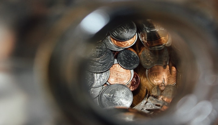 Shallow focus image of coins in jar